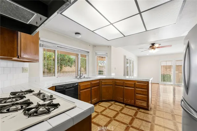 a kitchen with stainless steel appliances a refrigerator and a stove top oven