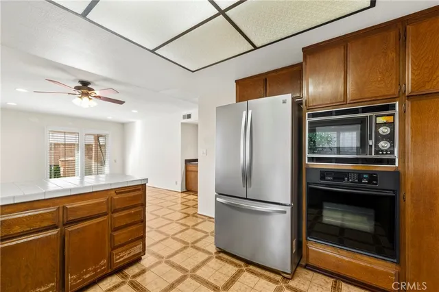 a kitchen with stainless steel appliances granite countertop a refrigerator and a stove