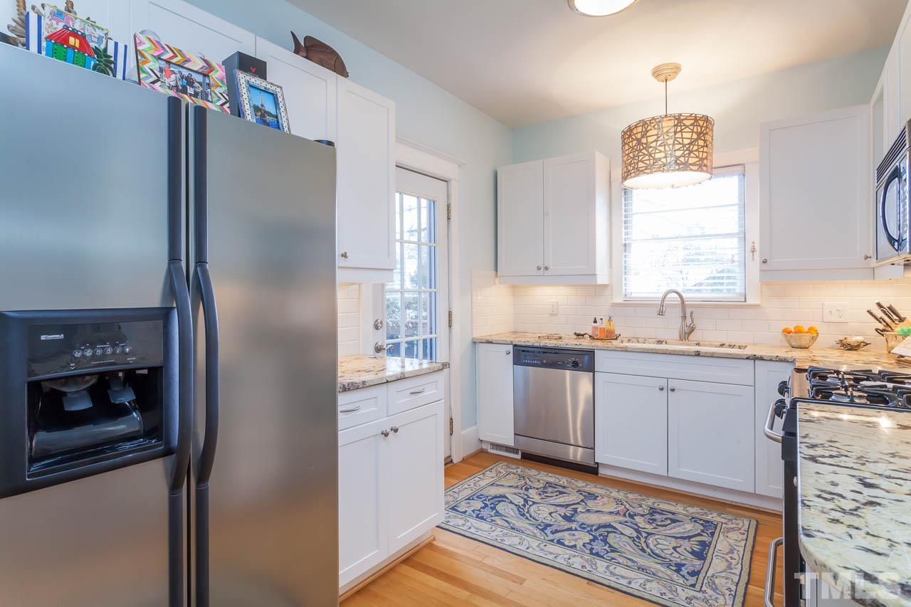 1702 Dare Street Raleigh, NC 27608 - Photo 11 of 25 a kitchen with granite countertop a refrigerator and a sink