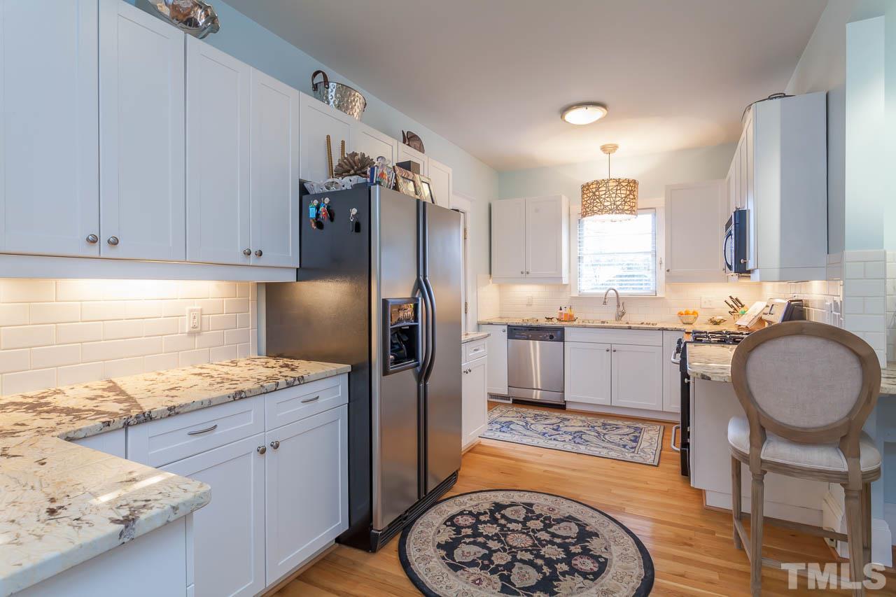 1702 Dare Street Raleigh, NC 27608 - Photo 12 of 25 a kitchen with stainless steel appliances granite countertop a sink stove and refrigerator