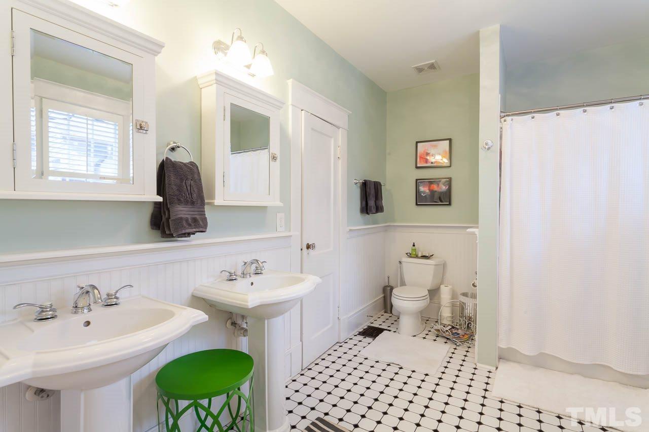 1702 Dare Street Raleigh, NC 27608 - Photo 15 of 25 a bathroom with a sink a toilet and a mirror