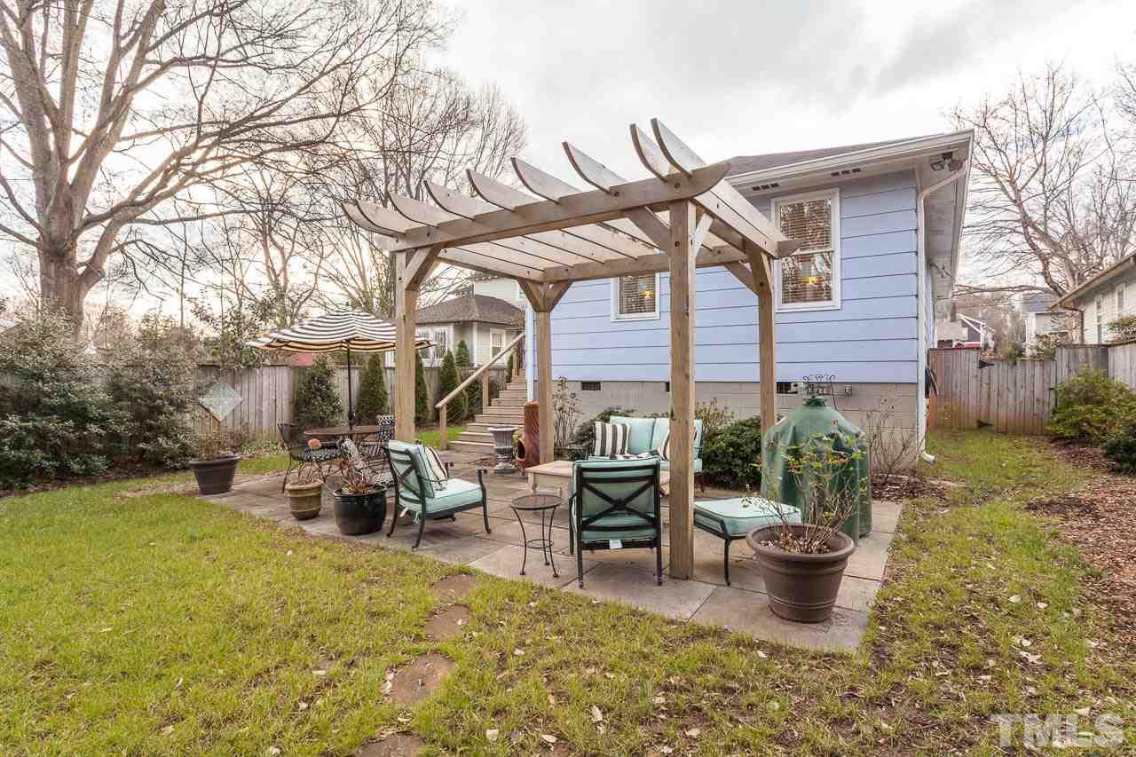 1702 Dare Street Raleigh, NC 27608 - Photo 22 of 25 a view of a patio with table and chairs potted plants and large tree