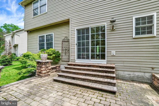 a view of a house with a small window and potted plants