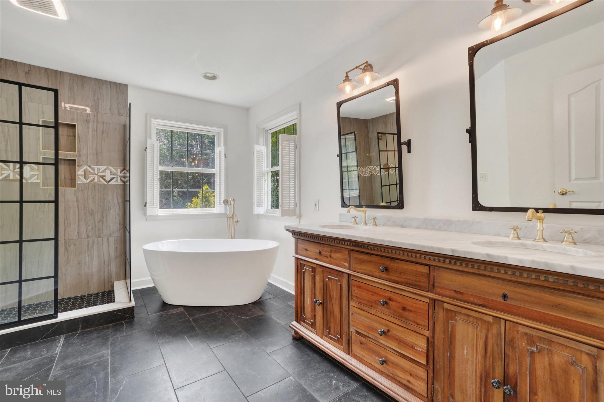 857 Willow Ridge Court York, PA 17404 - Photo 19 of 27 a spacious bathroom with a double vanity sink a mirror and a bathtub