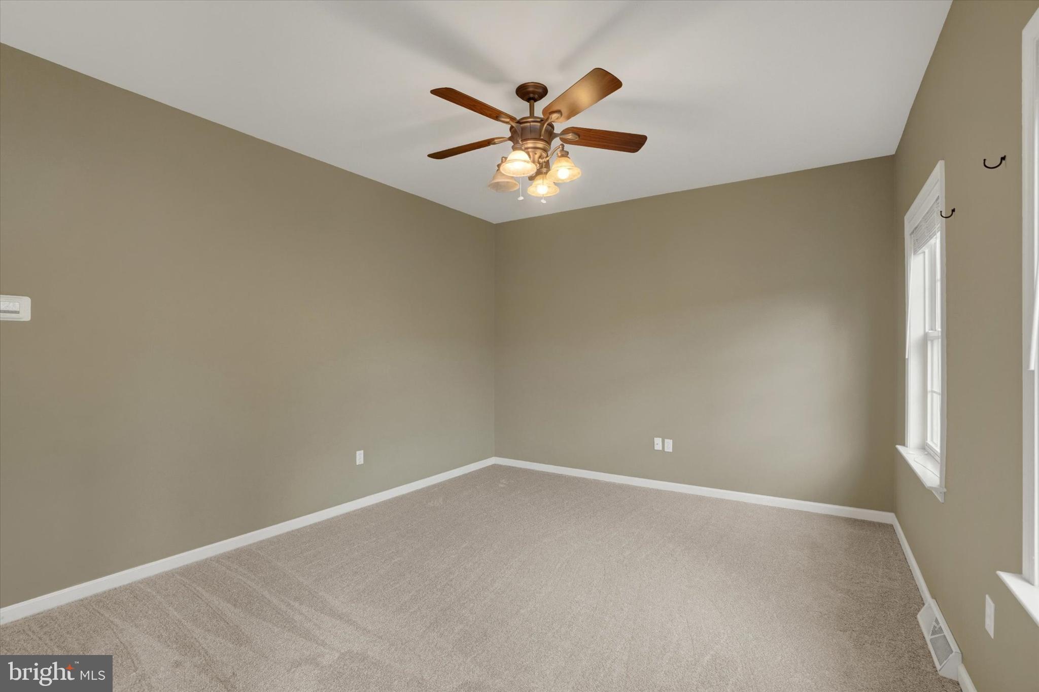 857 Willow Ridge Court York, PA 17404 - Photo 4 of 27 wooden floor in an empty room with a window