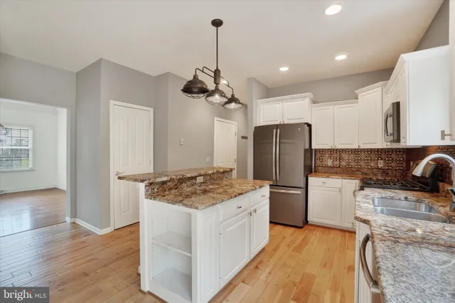 a kitchen with a stove a refrigerator and a sink