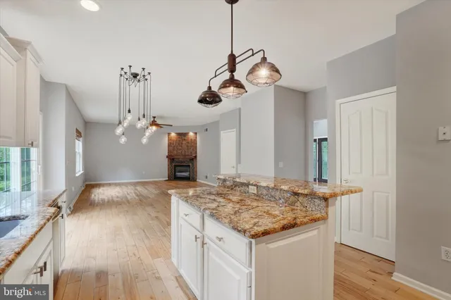 a kitchen with a table and chandelier