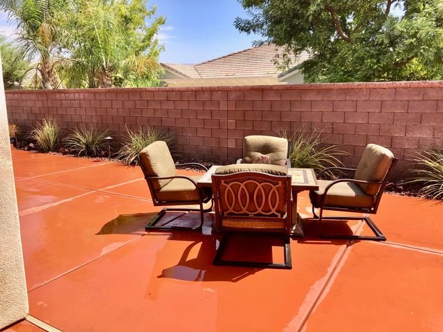a backyard of a house with table and chairs