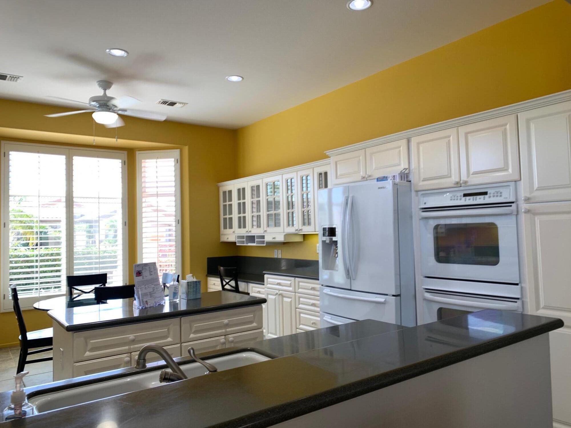 35932 Beringer Road Palm Desert, CA 92211 - Photo 16 of 44 a kitchen with stainless steel appliances granite countertop a sink a stove and cabinets