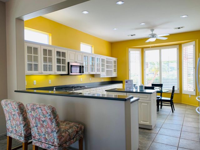 a view of a kitchen with dining table and chairs