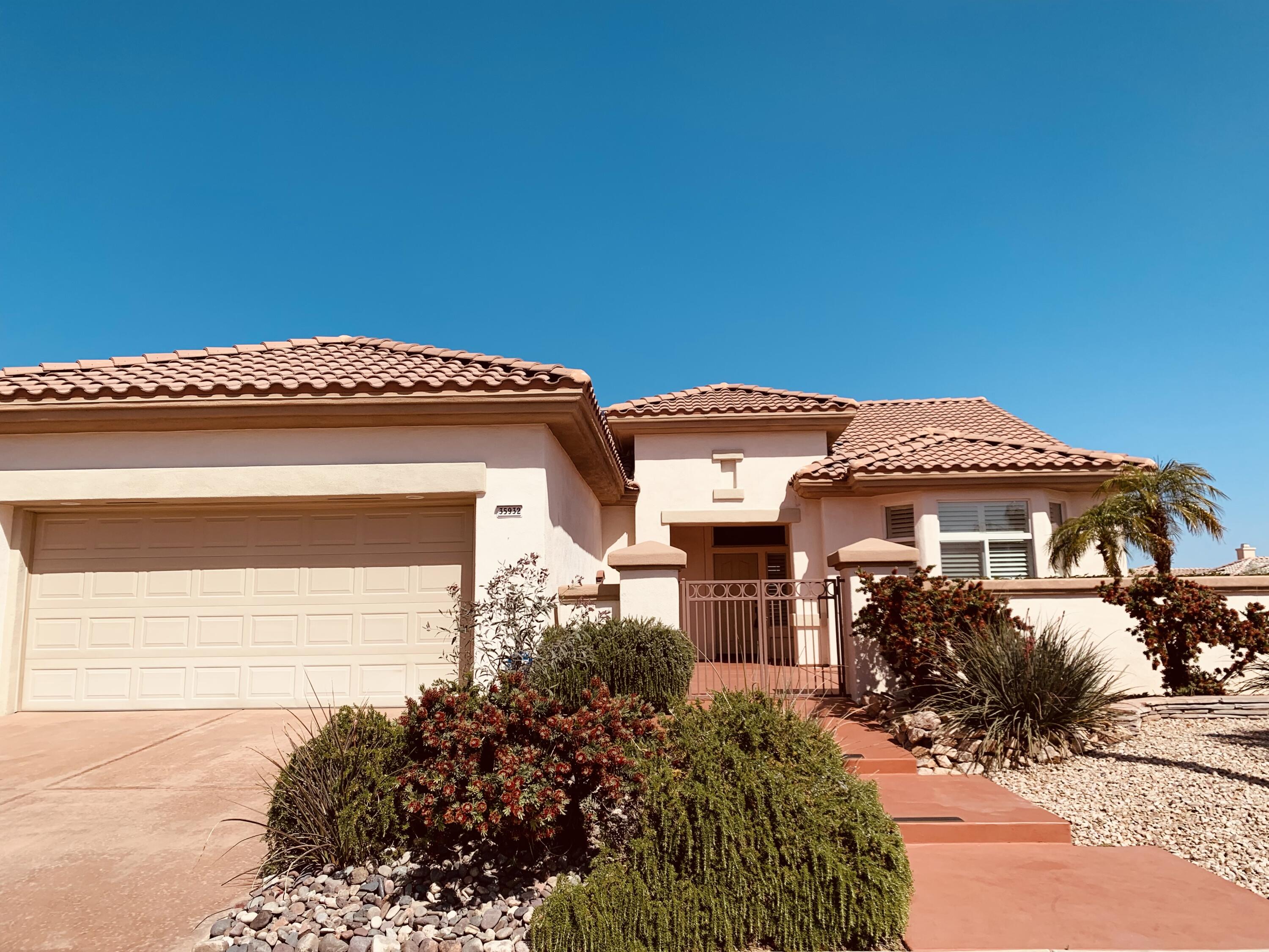 35932 Beringer Road Palm Desert, CA 92211 - Photo 2 of 44 a front view of a house with a yard