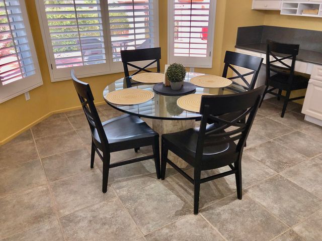 a dining room with furniture and window