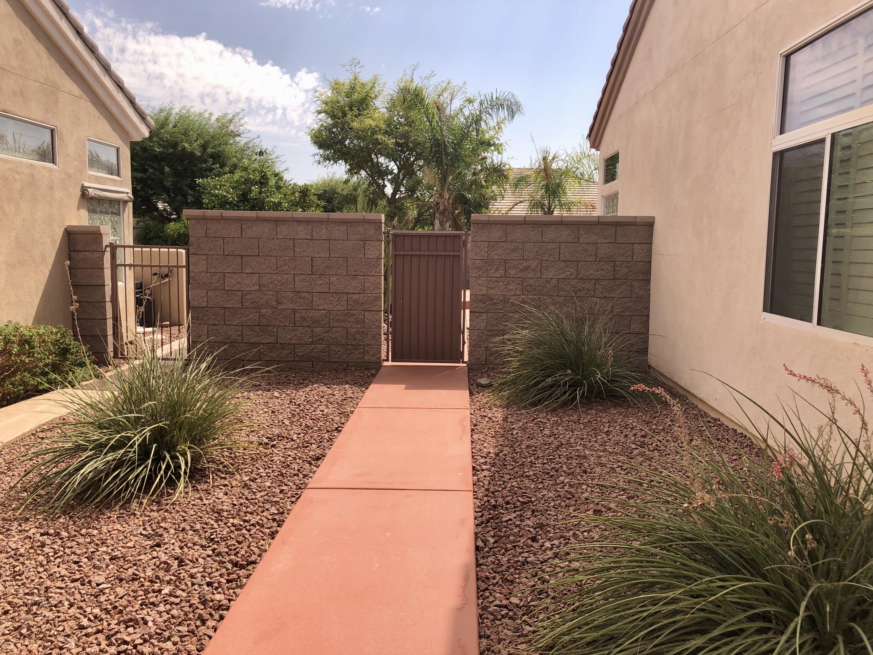 35932 Beringer Road Palm Desert, CA 92211 - Photo 6 of 44 a backyard of a house with a large tree and wooden fence