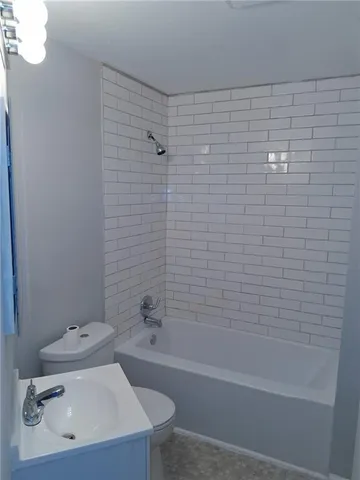a bathroom with a sink a toilet and bathtub
