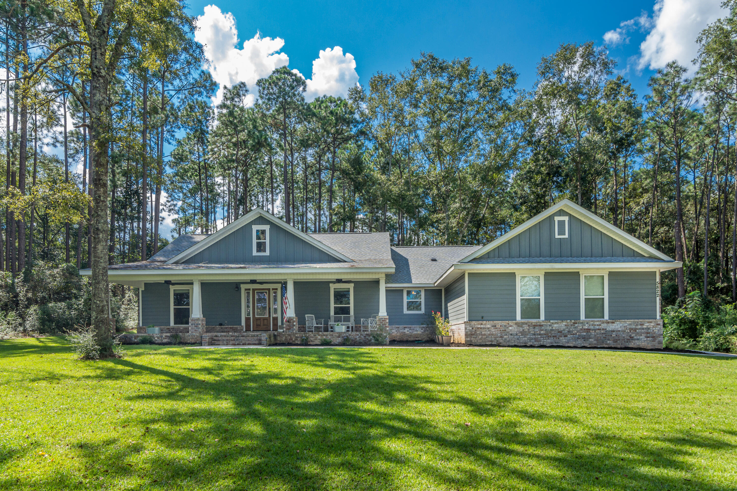5822 Dairy Road Baker, FL 32531 - Photo 1 of 47 a front view of a house with a garden