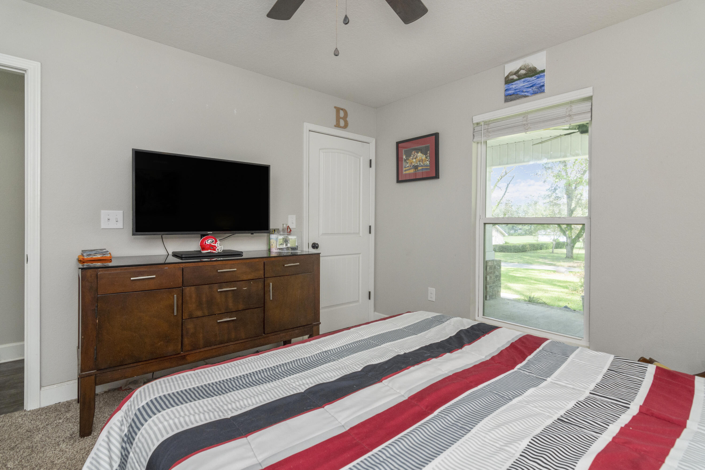 5822 Dairy Road Baker, FL 32531 - Photo 22 of 47 a bedroom with a bed and a flat screen tv