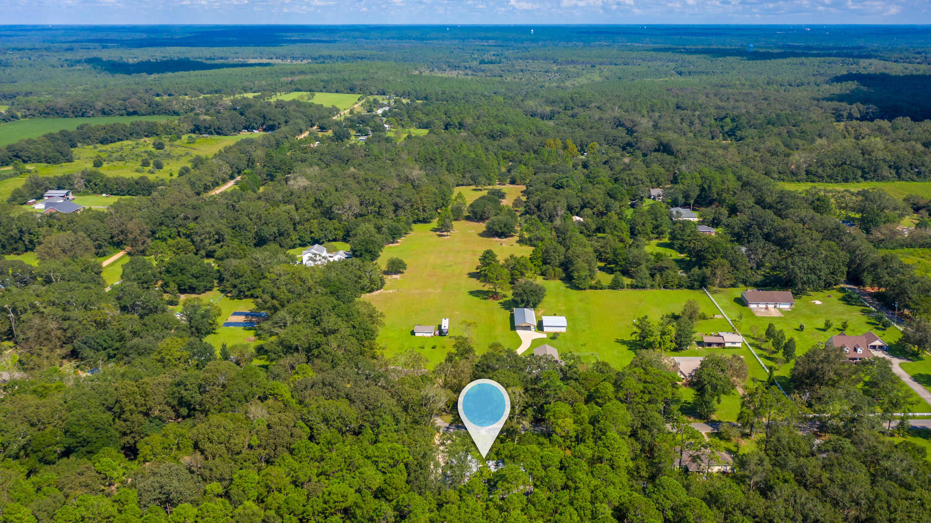 5822 Dairy Road Baker, FL 32531 - Photo 42 of 47 a view of a lake with a house