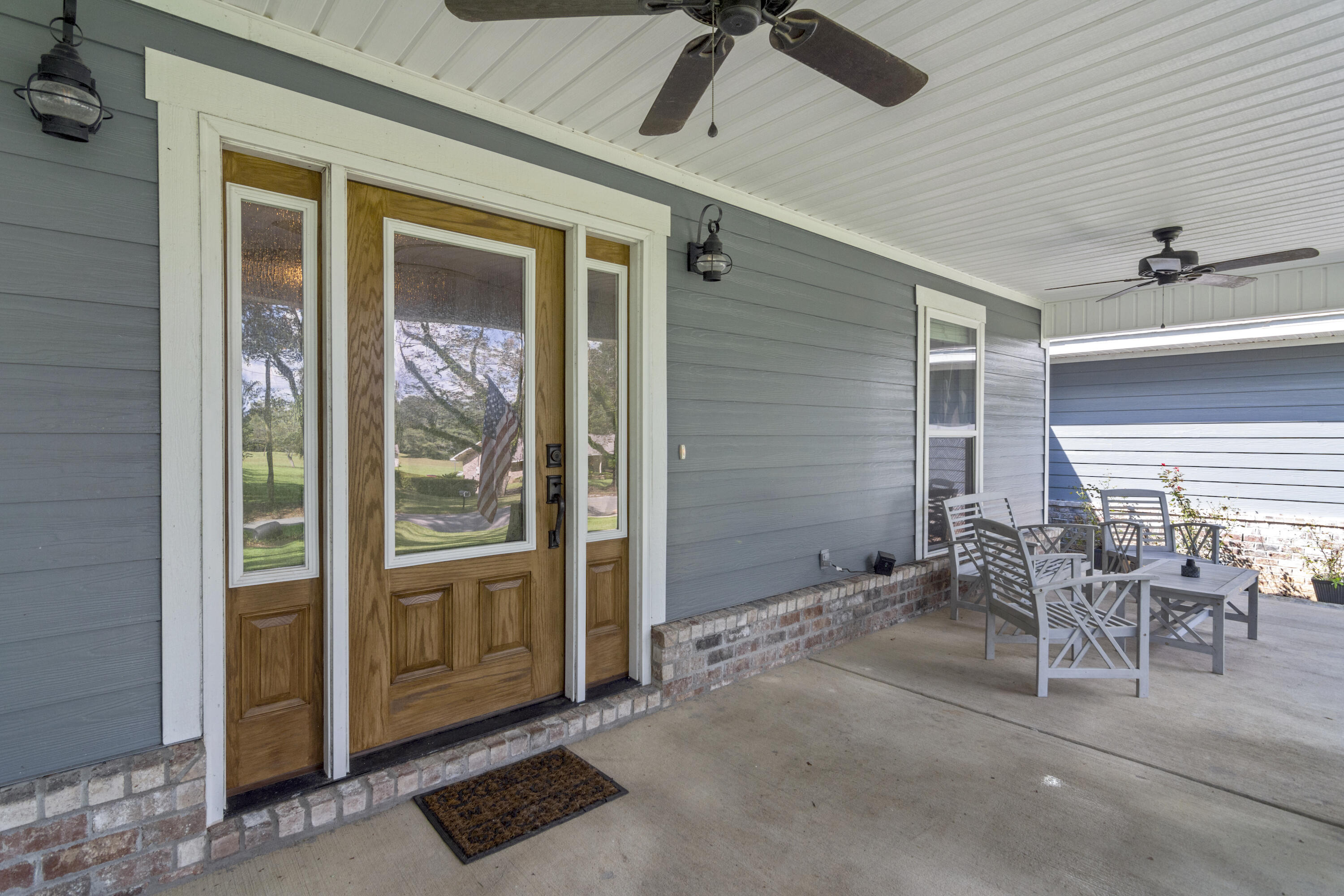 5822 Dairy Road Baker, FL 32531 - Photo 5 of 47 a view of a porch with chairs and backyard of the house