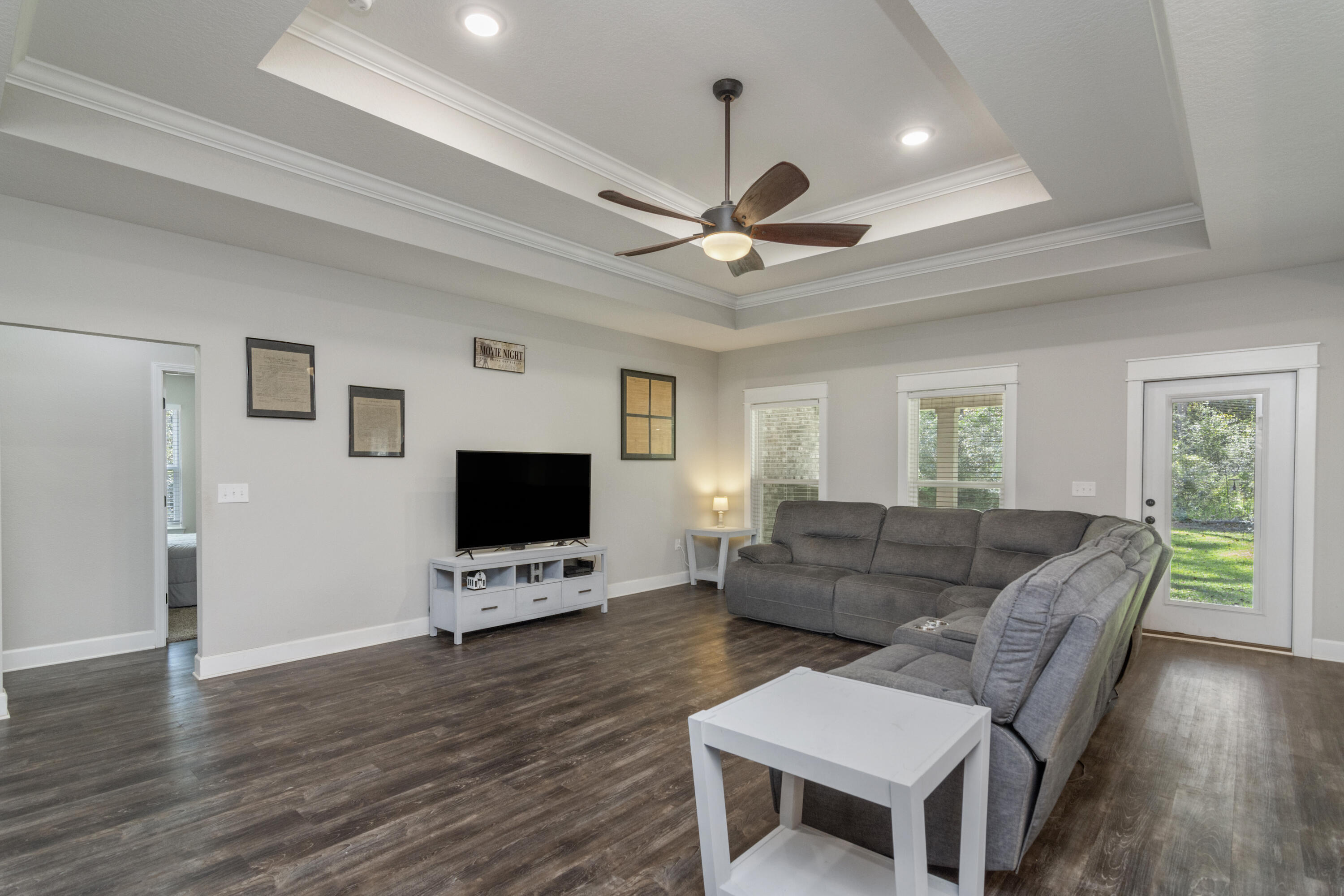 5822 Dairy Road Baker, FL 32531 - Photo 9 of 47 a living room with furniture a flat screen tv and a ceiling fan