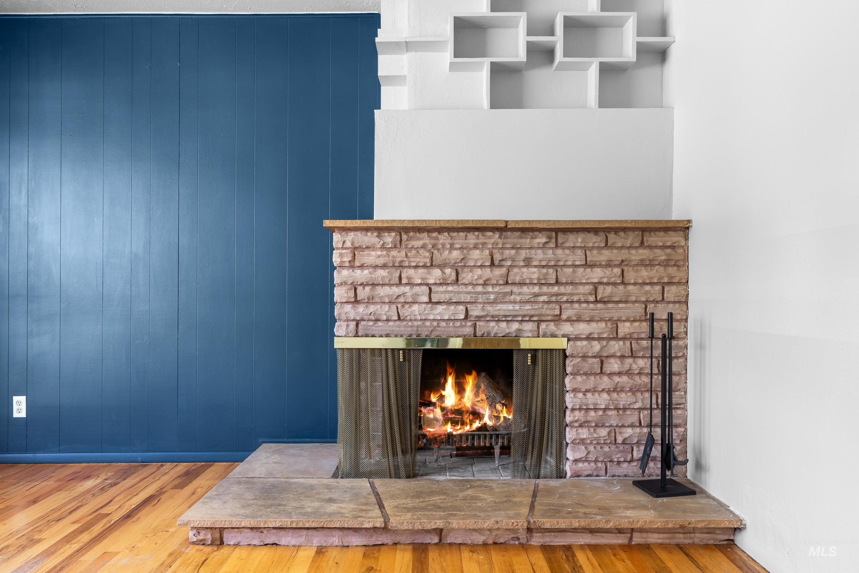 708 South Phillippi Street Boise, ID 83705 - Photo 5 of 25 Stone-clad fireplace with a hearth, brass surround, and integrated shelving