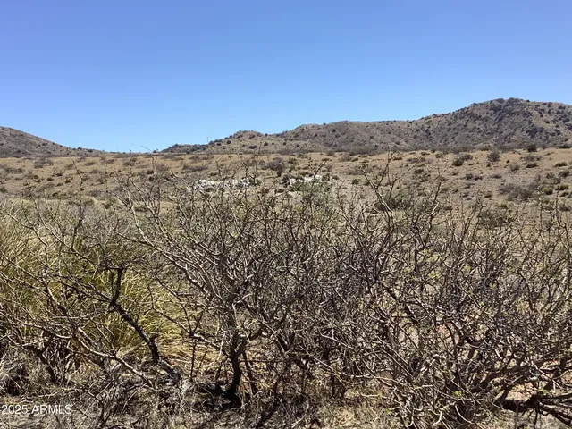 a view of a large mountain with mountains in the background