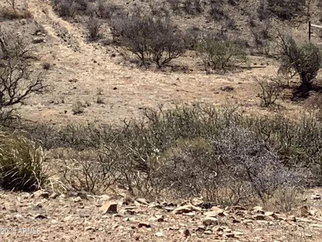 a view of a mountain range in a cloudy sky