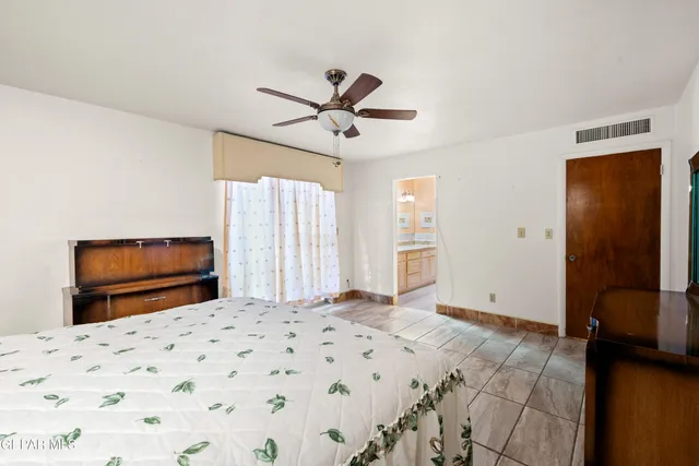a bathroom with a granite countertop double vanity sink a mirror and a shower