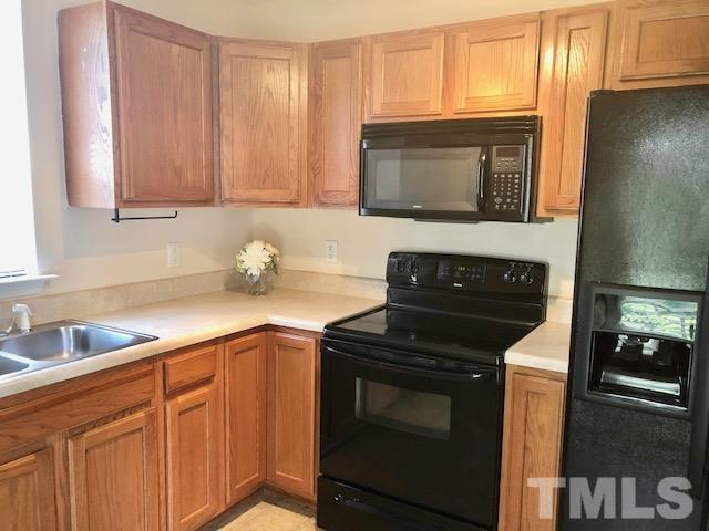 9810 Raleigh, NC 27617 - Photo 11 of 26 a kitchen with a stove microwave and sink