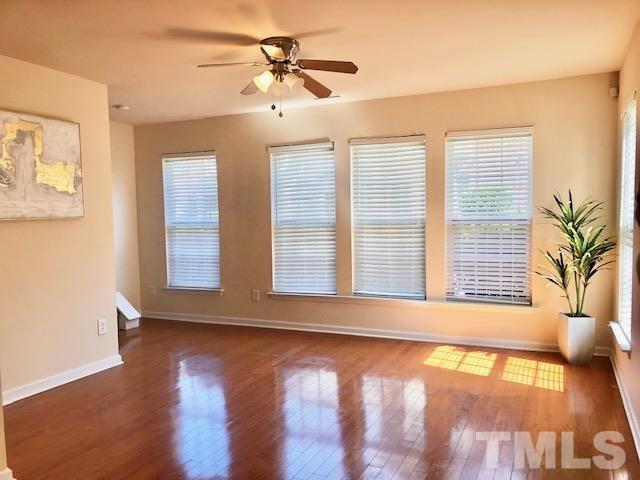 9810 Raleigh, NC 27617 - Photo 12 of 26 a view of an empty room with a window and wooden floor