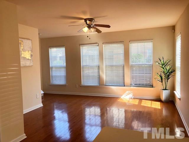 9810 Raleigh, NC 27617 - Photo 2 of 26 a view of an empty room with wooden floor and a window