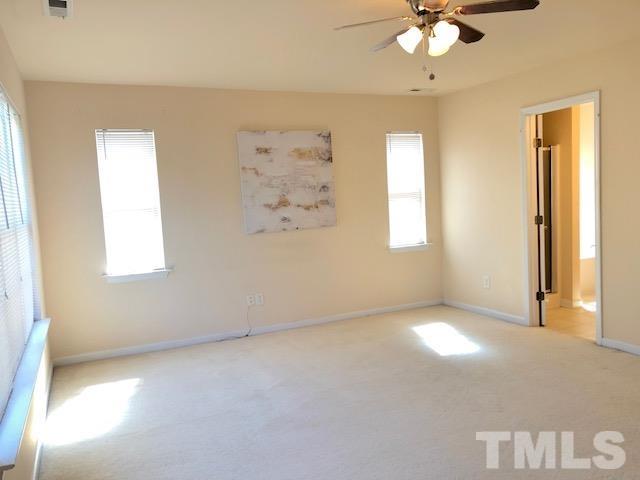 9810 Raleigh, NC 27617 - Photo 21 of 26 an empty room with windows and fan