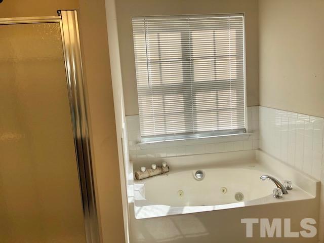 9810 Raleigh, NC 27617 - Photo 24 of 26 a bathroom with a bathtub and a shower