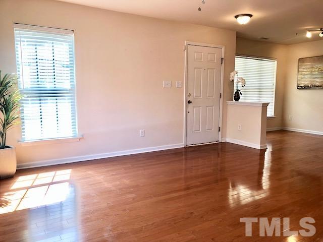 9810 Raleigh, NC 27617 - Photo 5 of 26 a view of empty room with wooden floor and fan