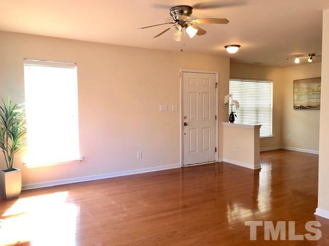 9810 Raleigh, NC 27617 - Photo 7 of 26 a view of an empty room with window and wooden floor