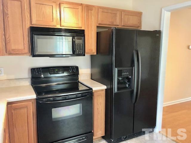 9810 Raleigh, NC 27617 - Photo 9 of 26 a kitchen with a refrigerator stove and microwave