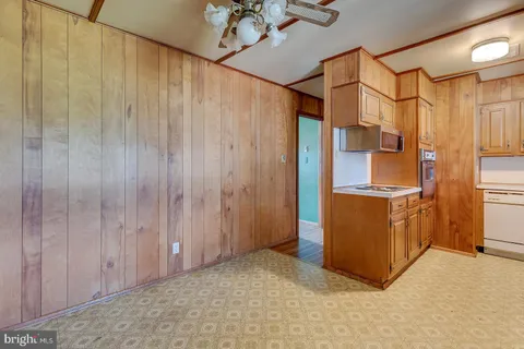 a kitchen with stainless steel appliances granite countertop a refrigerator and a stove