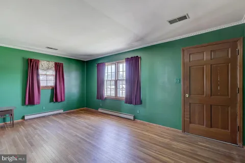 an empty room with windows and closet