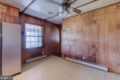 a kitchen with refrigerator and window