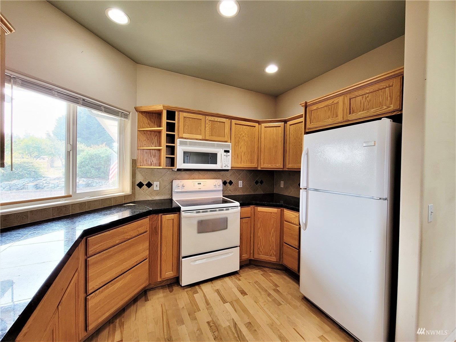131 Les Saints Road Sequim, WA 98382 - Photo 12 of 32 a kitchen with stainless steel appliances a refrigerator sink and microwave