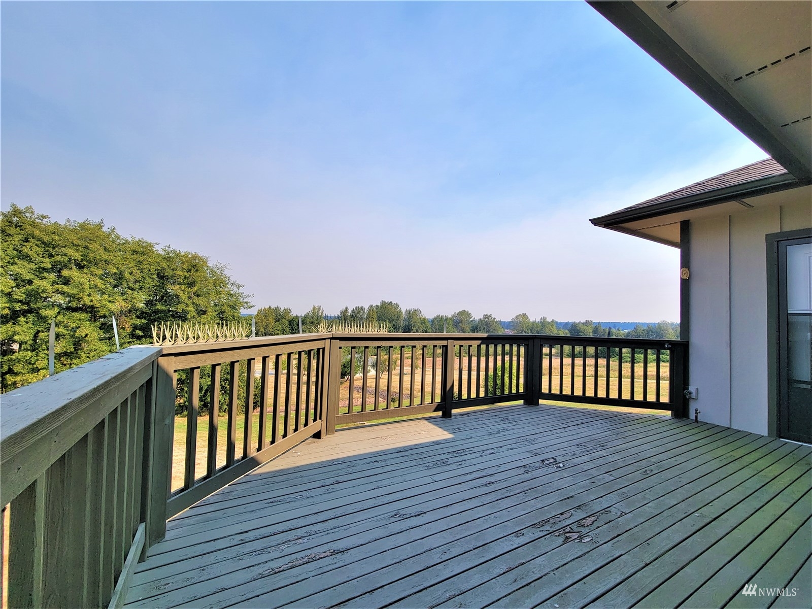 131 Les Saints Road Sequim, WA 98382 - Photo 26 of 32 a view of balcony with wooden floor and fence