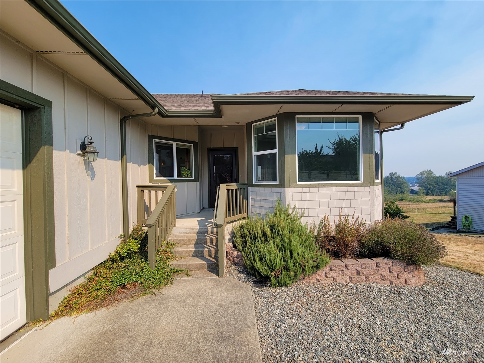 131 Les Saints Road Sequim, WA 98382 - Photo 4 of 32 a front view of a house with garden