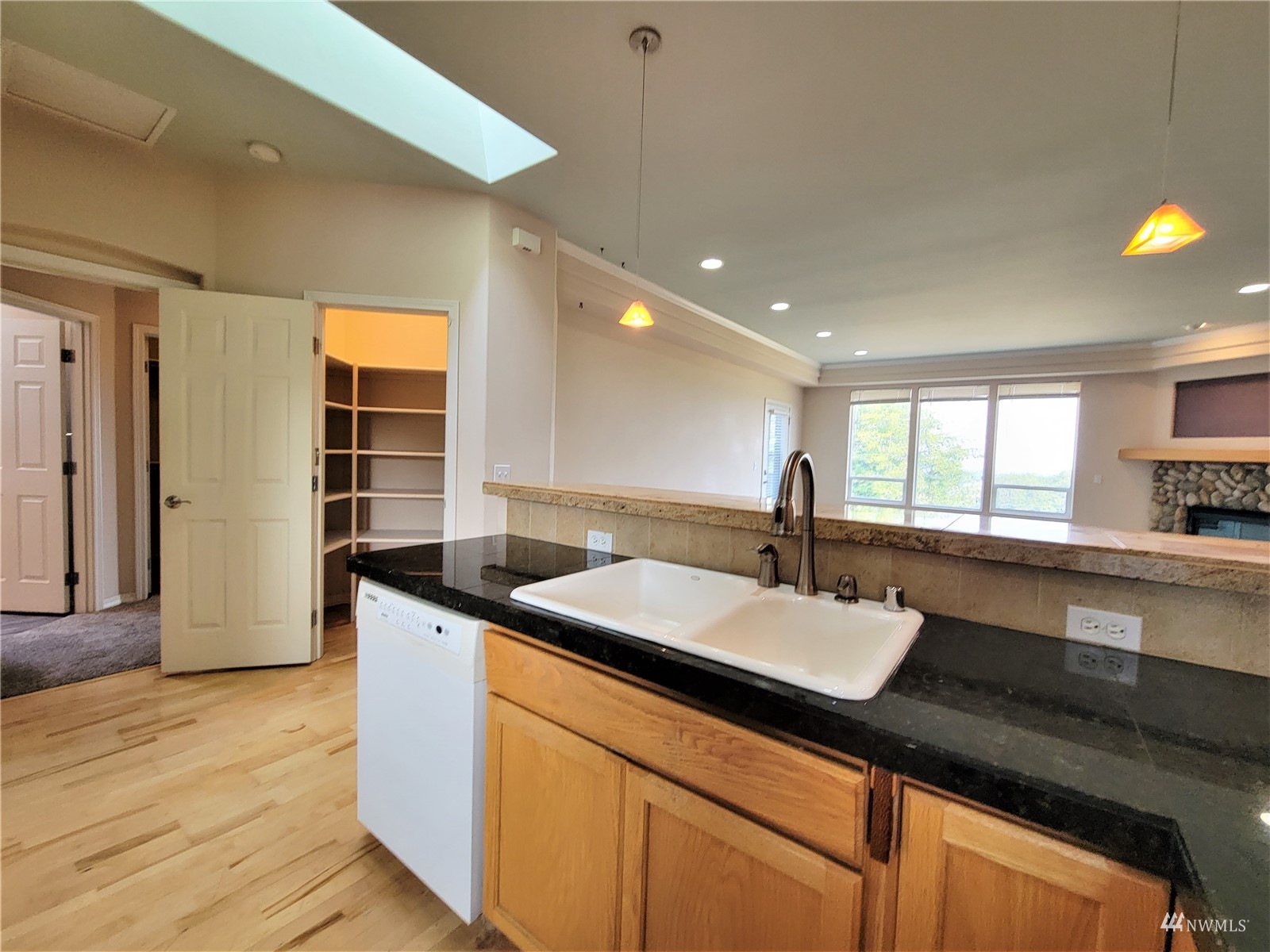 131 Les Saints Road Sequim, WA 98382 - Photo 9 of 32 a kitchen with granite countertop a sink and cabinets