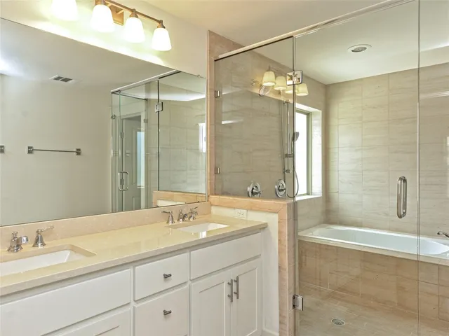 a bathroom with a double vanity sink mirror double and shower