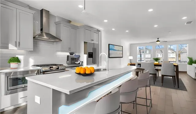 a kitchen with a sink a stove and chairs