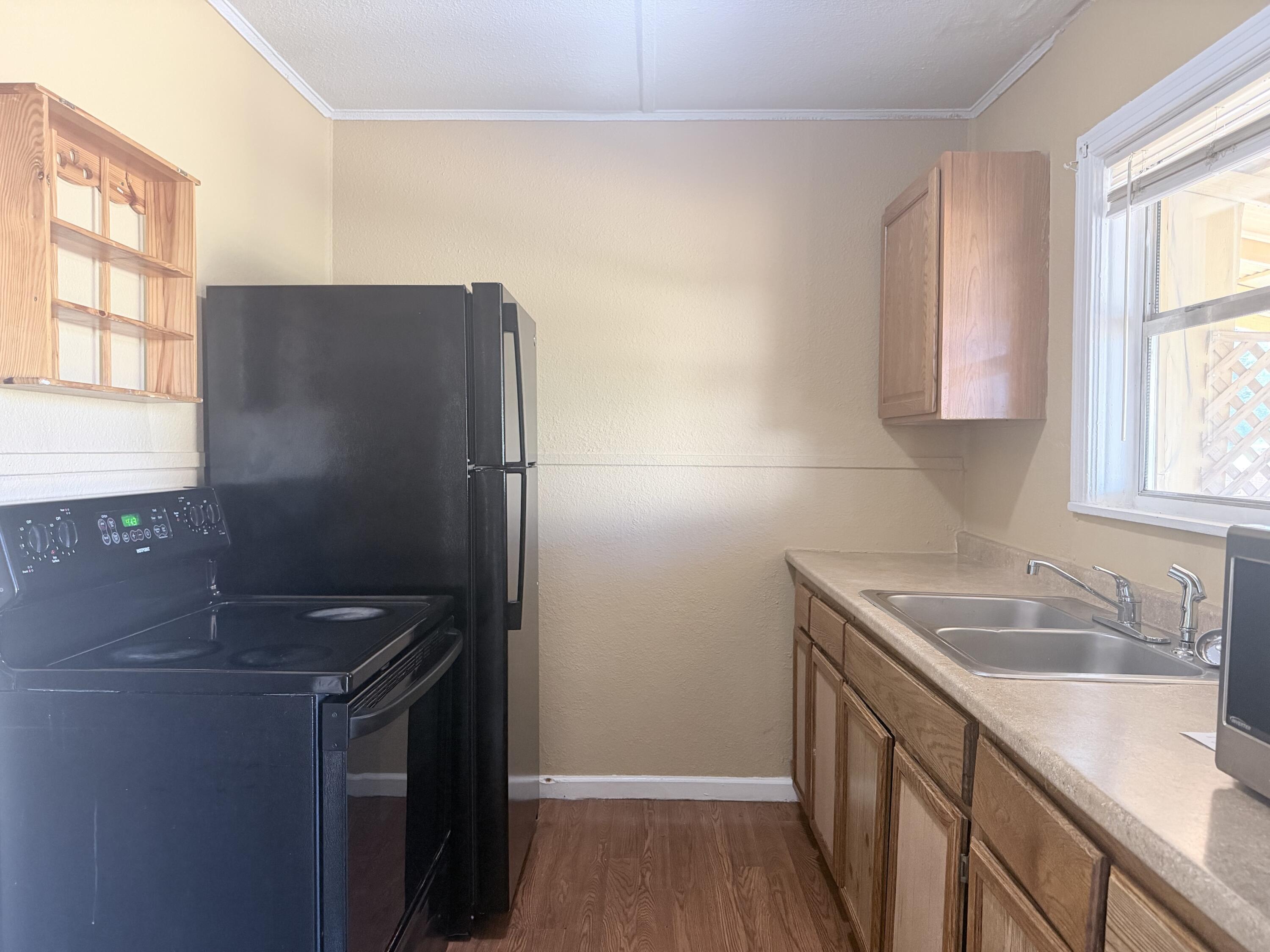 2230 El Reno Lane Redding, CA 96001 - Photo 22 of 27 a kitchen with stainless steel appliances granite countertop a sink stove and refrigerator