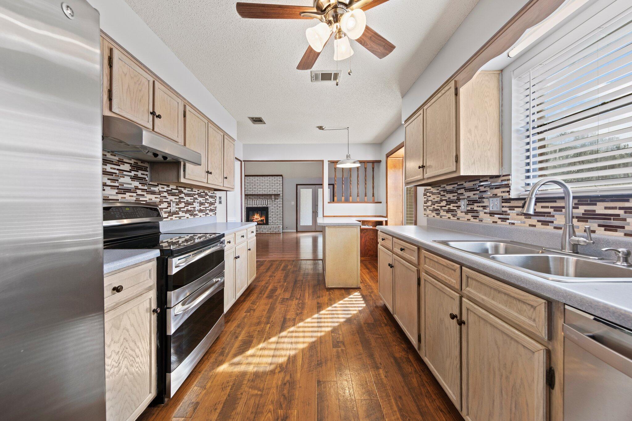 466 Olde Post Road Niceville, FL 32578 - Photo 11 of 49 a kitchen with stainless steel appliances sink cabinets and window