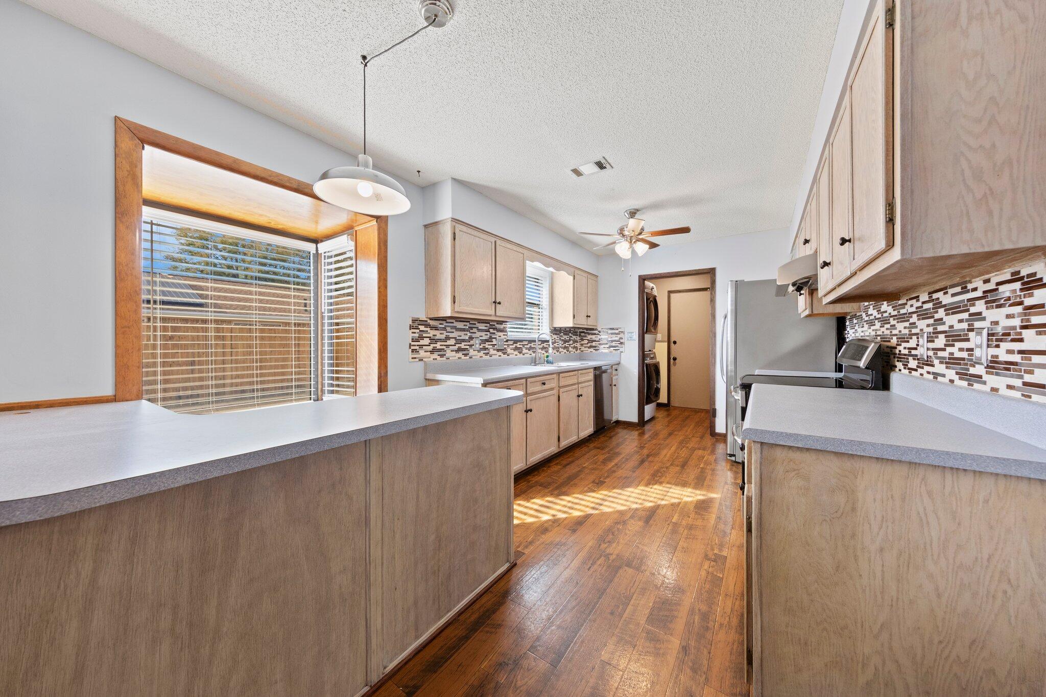 466 Olde Post Road Niceville, FL 32578 - Photo 14 of 49 a kitchen with stainless steel appliances granite countertop a stove and a wooden floors
