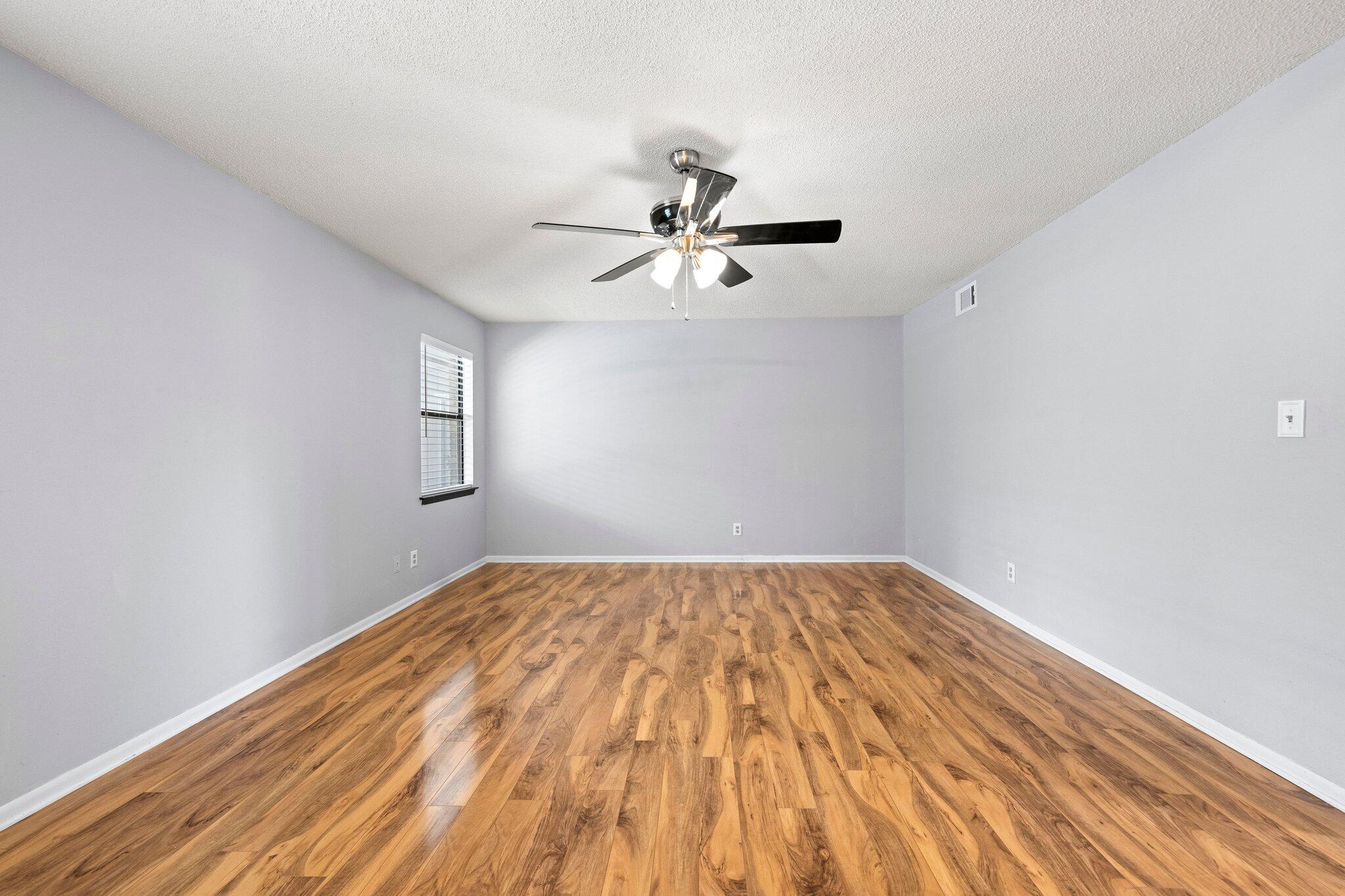 466 Olde Post Road Niceville, FL 32578 - Photo 18 of 49 a view of a big room with wooden floor and a chandelier fan