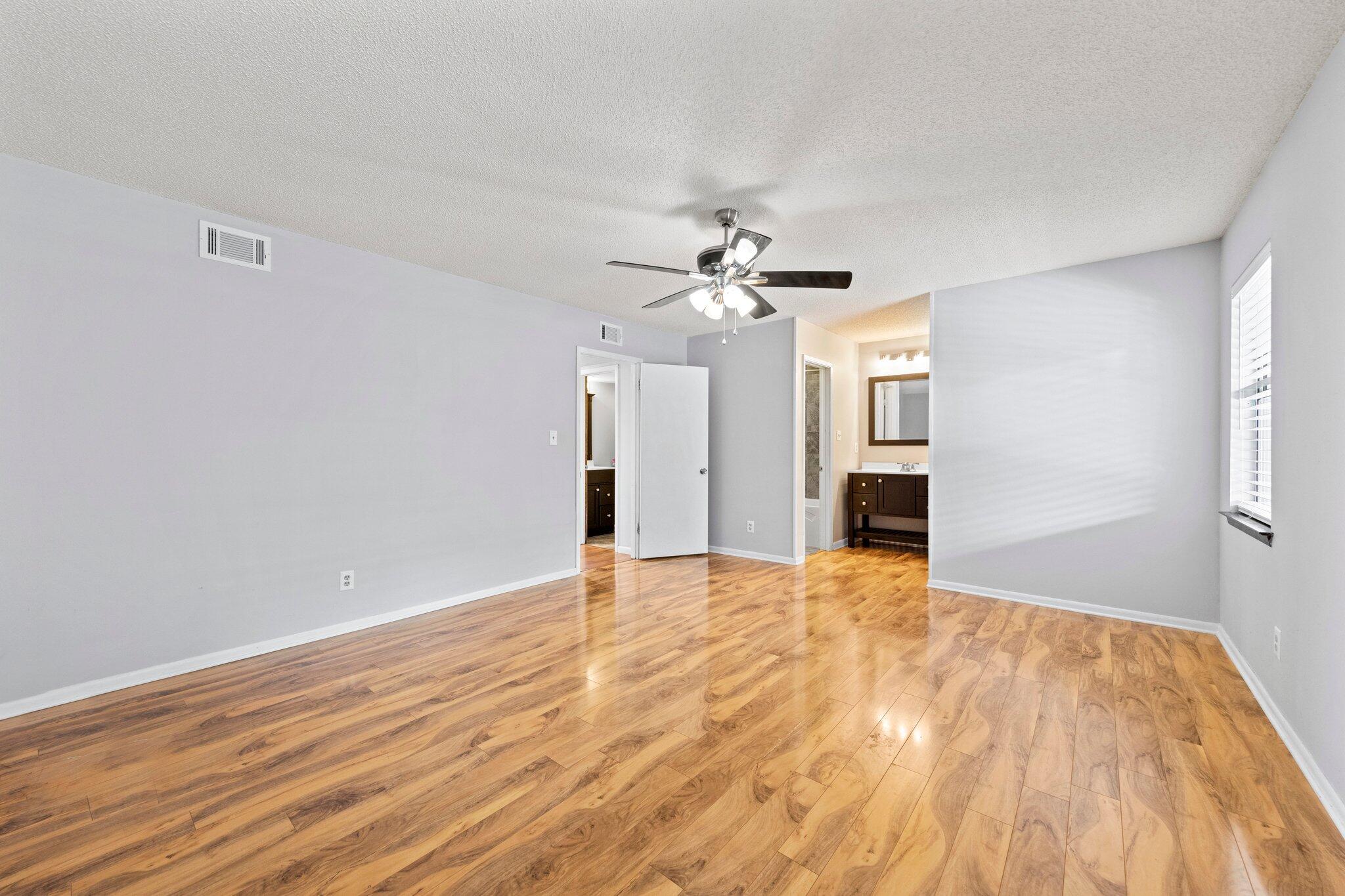 466 Olde Post Road Niceville, FL 32578 - Photo 19 of 49 a view of empty room with wooden floor and fan