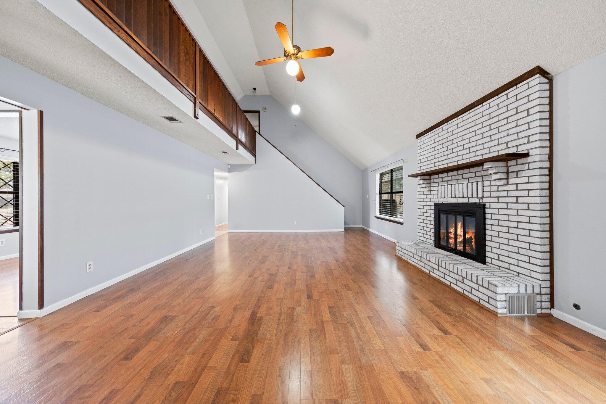466 Olde Post Road Niceville, FL 32578 - Photo 6 of 49 a view of a livingroom with wooden floor and a fireplace